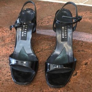 Stuart Weitzman black patent strapped sandals.